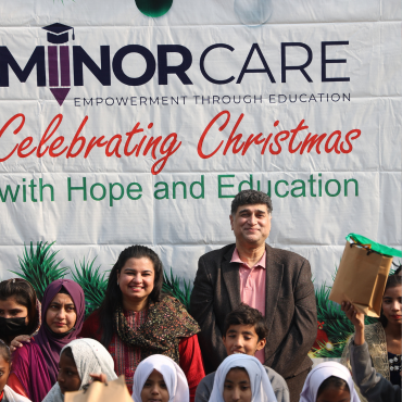 Founder Mo Azeem and Sana standing and smiling with a MinorCare school teacher.