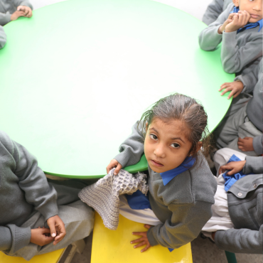 An aerial view of MinorCare students sitting in a classroom in Pakistan.