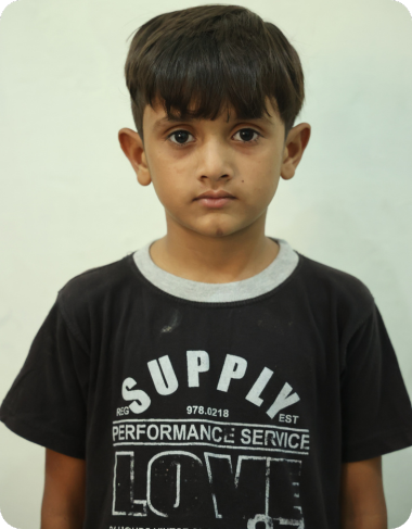 A very young Christian boy at MinorCare looking directly at the camera.