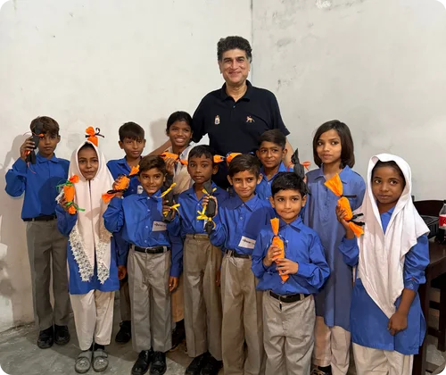 Founder Mo Azeem is standing with Christian children at MinorCare, supporting their education and hope for a brighter future.