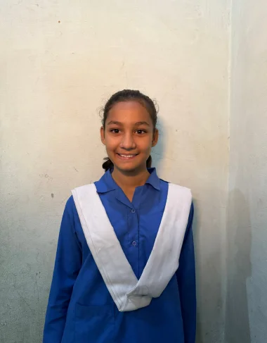 Aaster Aslam, a Christian Grade 4 student supported by MinorCare, smiling in his classroom in Pakistan.