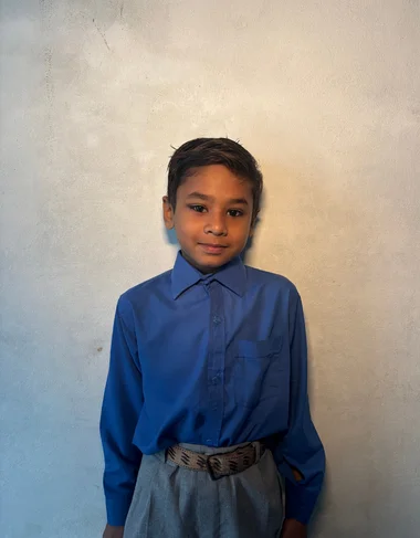 Ahad Tanveer, a Christian Grade 2 student supported by MinorCare, smiling in his classroom in Pakistan.