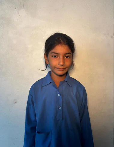 Al-Haram Shehbaz, a Christian Grade 2 student supported by MinorCare, smiling in his classroom in Pakistan.