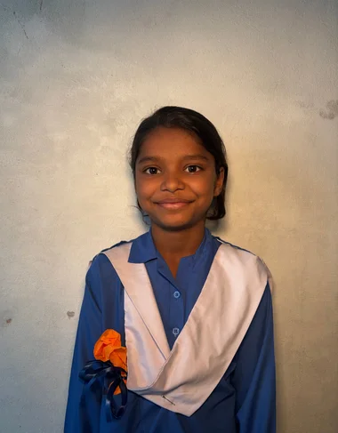 Angel Shrafat, a Christian Grade 2 student supported by MinorCare, smiling in her classroom in Pakistan.