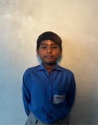 Arhan Akram, a Christian Grade 2 student supported by MinorCare, smiling in his classroom in Pakistan.
