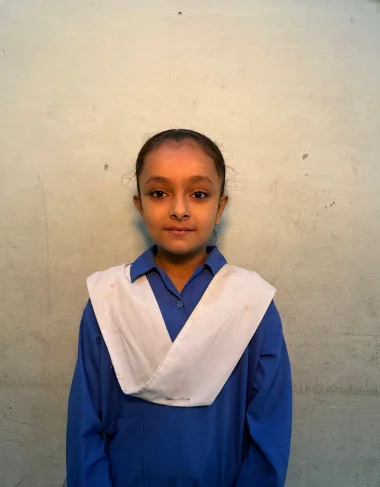 Arooj Shehzad, a Christian Grade 4 student supported by MinorCare, smiling in her classroom in Pakistan.