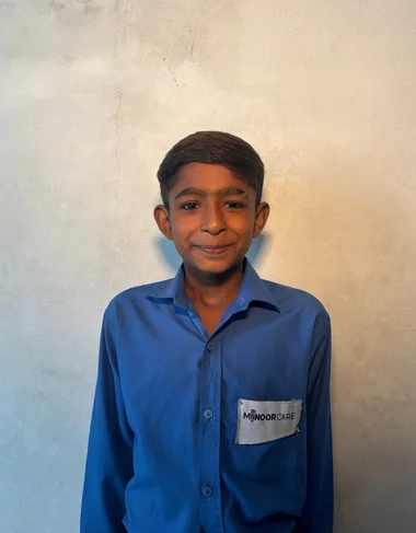 Ayoosh Shehzad, a Christian Grade 2 student supported by MinorCare, smiling in his classroom in Pakistan.