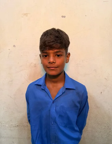 Dawood Siddique, a Christian Grade 3 student supported by MinorCare, smiling in his classroom in Pakistan.