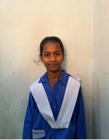 Maryam Aslam, a Christian Grade 4 student supported by MinorCare, smiling in her classroom in Pakistan.