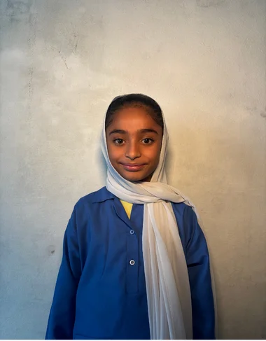Minahil Umar, a Christian Grade 2 student supported by MinorCare, smiling in her classroom in Pakistan.