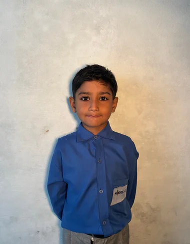 Rehman Jameel, a Christian Grade 2 student supported by MinorCare, smiling in his classroom in Pakistan.