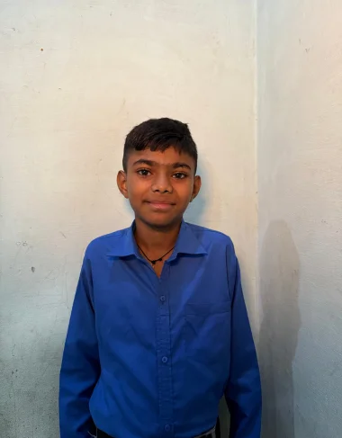 Sameer Siddique, a Christian Grade 4 student supported by MinorCare, smiling in his classroom in Pakistan.
