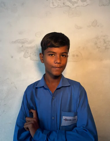 Samuel, a Christian Grade 5 student supported by MinorCare, smiling in his classroom in Pakistan.