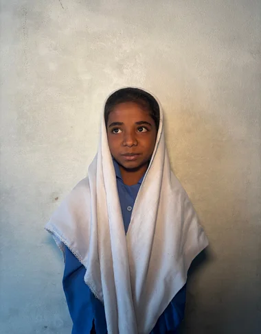 Sana Mohsin, a Christian Grade 2 student supported by MinorCare, smiling in her classroom in Pakistan.