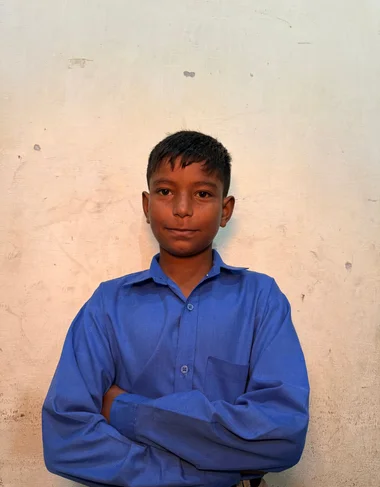 Shamoon Farman, a Christian Grade 3 student supported by MinorCare, smiling in his classroom in Pakistan.
