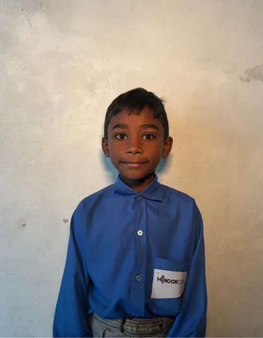 Sufyan Shehzad, a Christian Grade 2 student supported by MinorCare, smiling in his classroom in Pakistan.