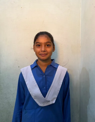 Suneha Irfan, a Christian Grade 4 student supported by MinorCare, smiling in her classroom in Pakistan.