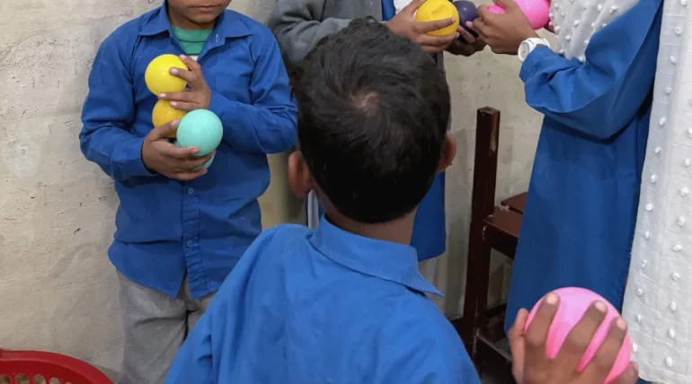Christian children at MinorCare smiling and learning together in a supportive classroom environment in Pakistan.