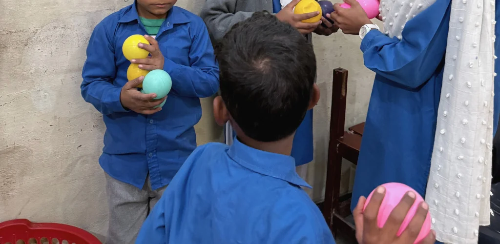 Christian children at MinorCare smiling and learning together in a supportive classroom environment in Pakistan.