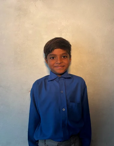 Shaluk Shrafat, a Christian Grade 2 student supported by MinorCare, smiling in his classroom in Pakistan.