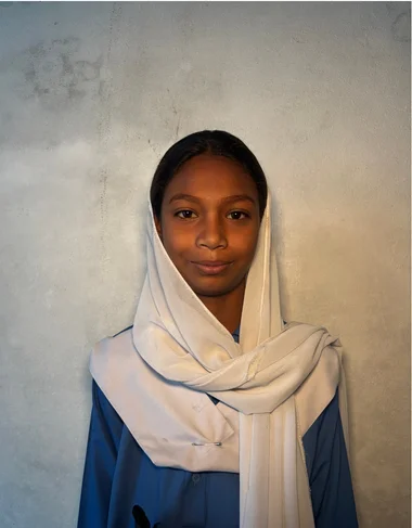 Wania, a Christian Grade 2 student supported by MinorCare, smiling in her classroom in Pakistan.